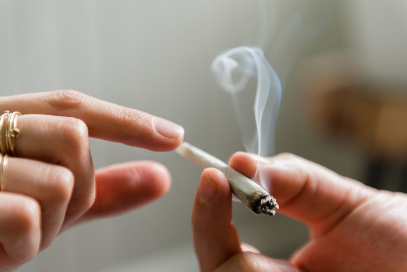 Two people passing a joint, marijuana, weed