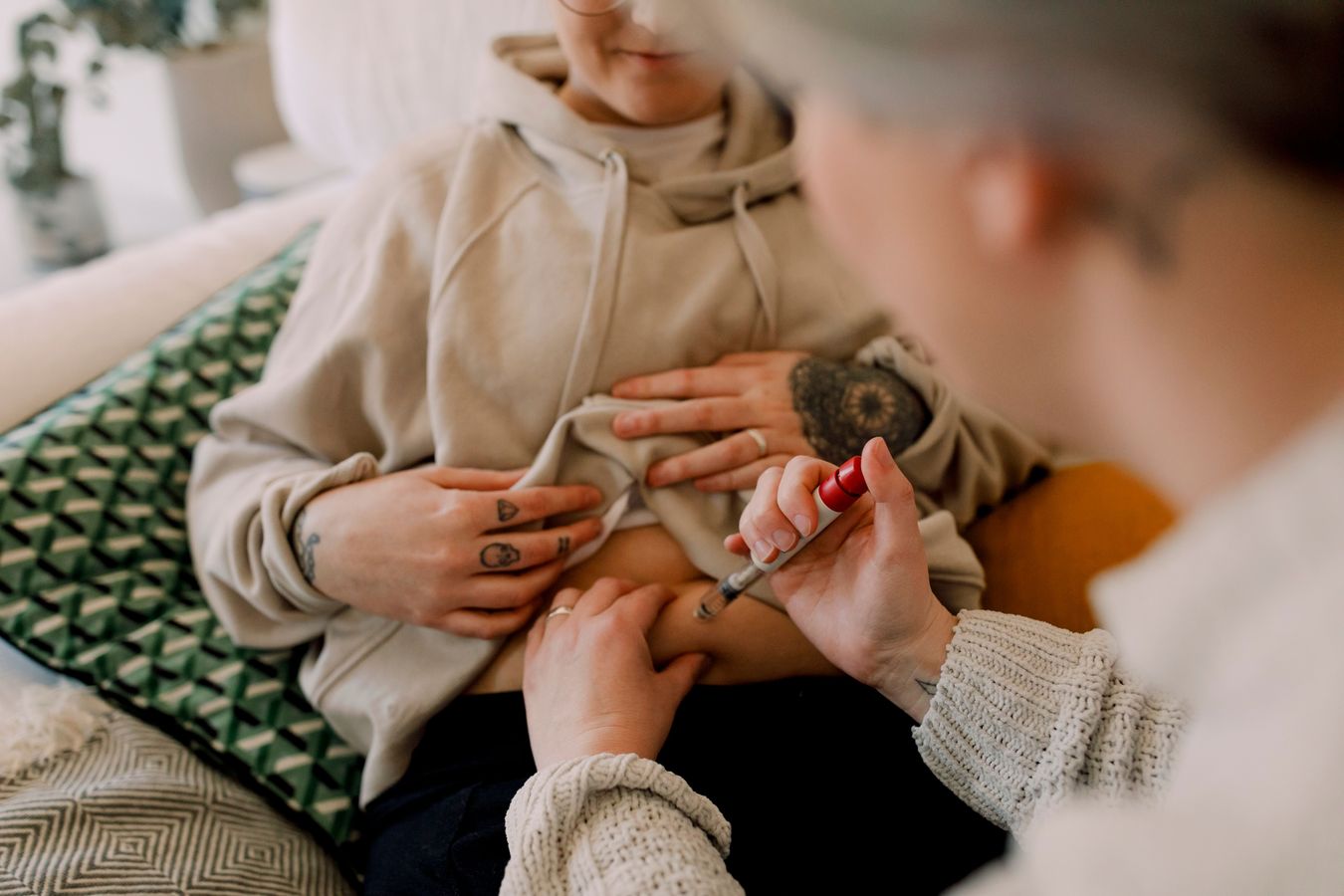 A woman receiving a shot from a doctor to prepare for IVF 