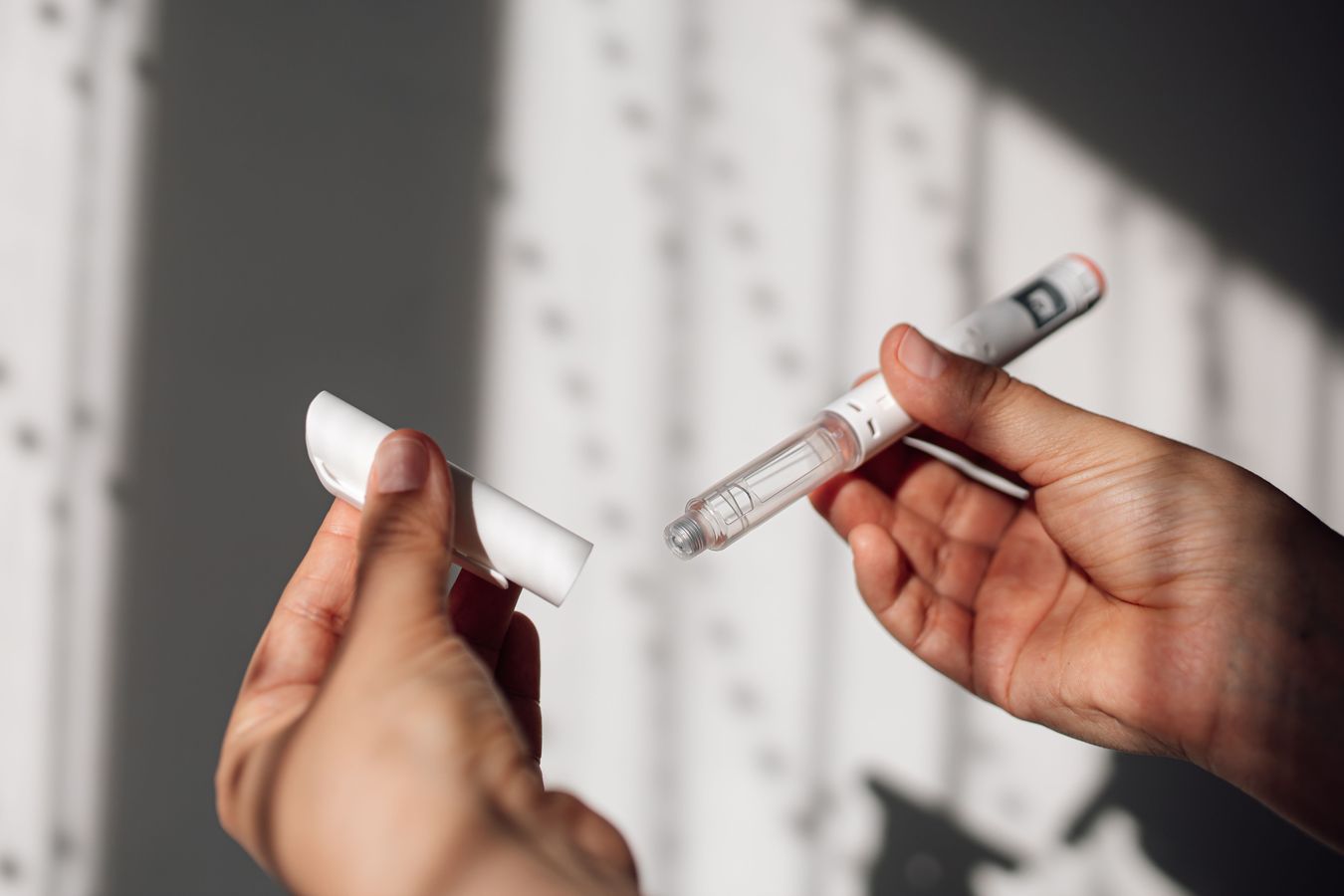 Semaglutide injection pen or cartridge pen for diabetics and weight loss in female hand. Medical equipment for diabetes patients